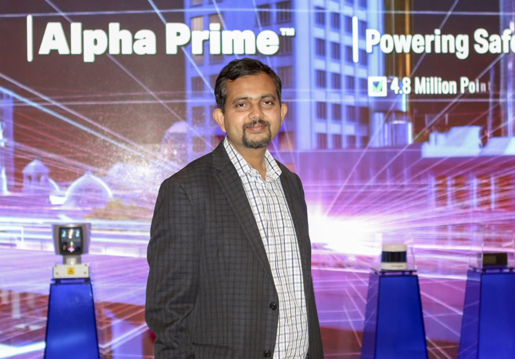 Anand Gopalan, CEO of Velodyne Lidar, standing in front of lidar sensor display at CES 2020
