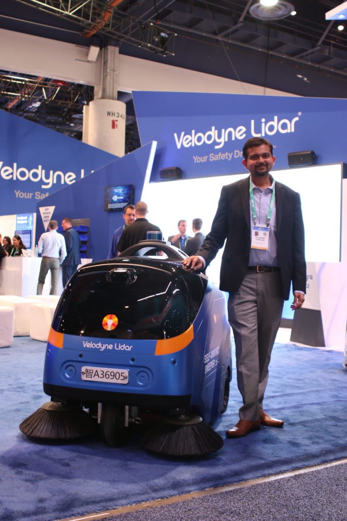 Anand Gopalan Velodyne Lidar CEO at CES 2020 standing next to an Idriverplus Automated Street Sweeper