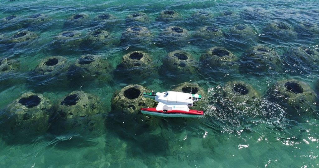Autonomous surface vessel monitoring a nearshore artificial reef.